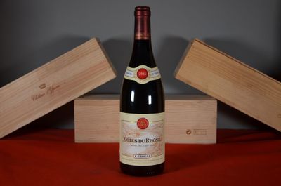 a bottle of wine sitting on a table next to two wooden boxes