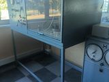 a fish tank sitting on top of a stand next to a window