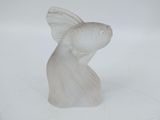 a white fish figurine sitting on a white surface