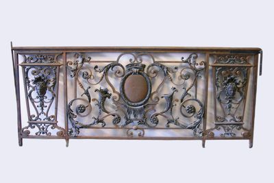 a metal fence that has a decorative design on it