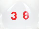 a white piggy bank with red numbers on it