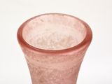 a pink vase sitting on a table with a white background