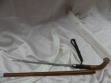 a pair of scissors and a cane on a white cloth