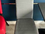 two chairs and a table in a room with a blue wall