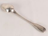 a spoon that is sitting on a white surface