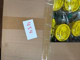 a cardboard box with a bunch of yellow buttons in it