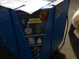 a blue machine that is sitting on the ground