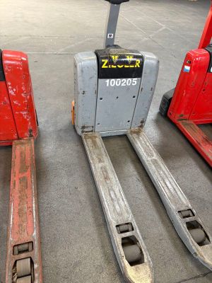two red forklifts sitting next to each other in a warehouse