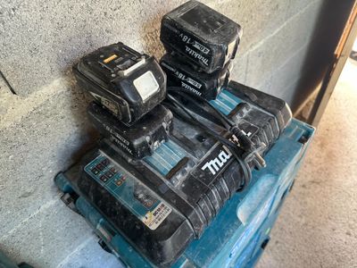 a pile of power tools sitting on top of a blue box