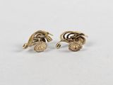 a pair of gold plated earrings with a bird on the back
