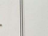a lamp that is sitting on the floor next to a wall