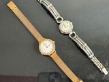 two watches that are sitting next to each other on a table
