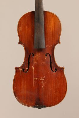 an old violin with a bow hanging from it ' s back