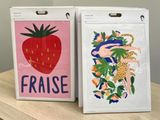 two bags with a picture of a strawberry and a leopard on them