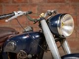 a close up of a motorcycle parked in front of a brick wall