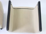 pair of beige leather chairs with black trims and black legs