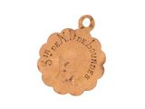 a close up of a gold charm with a flower on it