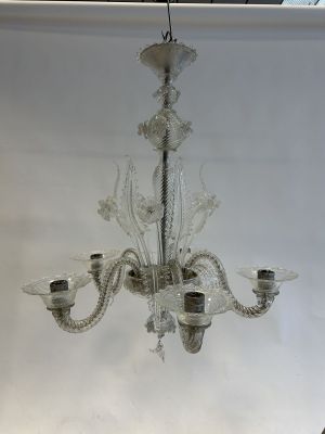 a glass chandelier hanging from a ceiling in a room