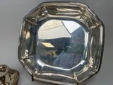 a silver plate with a mirror on top of it