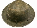 an old helmet with holes on the side of it on a white surface