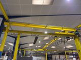 a large yellow crane in the middle of a building