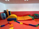 a room with a lot of play equipment on the floor