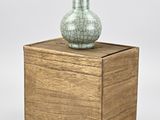a vase sitting on top of a wooden box