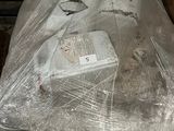 a toilet that is wrapped in plastic and sitting on a pallet