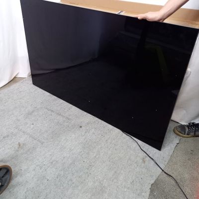 a man that is standing next to a black television