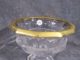 a glass bowl with a gold rim sitting on a table