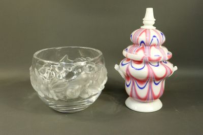 a small vase and a small glass on a table