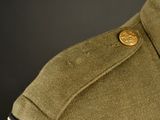 a close up of a military uniform with a button on it