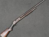 a rifle with a wooden barrel and a metal handle
