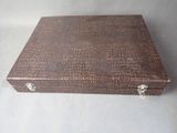 a small wooden box with a handle on a table