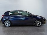 the blue car is parked in a large room with a white wall