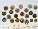 many different types of coins in small bowls on the table
