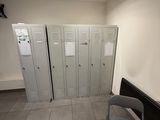 a room with lockers and a red table in it