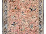 an antique persian rug with birds and flowers on a pink ground