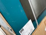 a box that has some papers on it in front of a blue wall