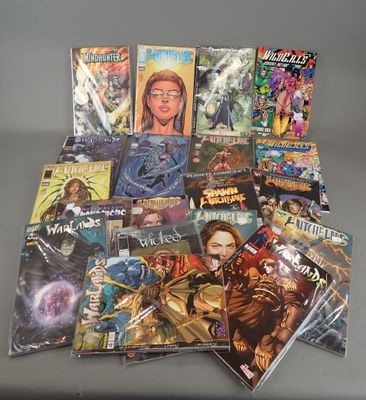 many comic books are stacked on top of each other on a table