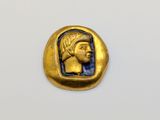 a gold and blue coin with a head of a woman