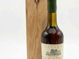 an image of a bottle of wine sitting next to a wooden box