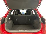 the back of a red car with the trunk open