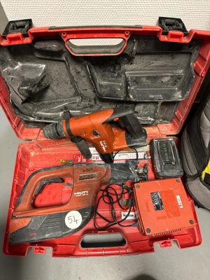 a red tool box with tools in it on the floor