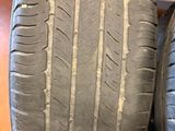 two tires are sitting side by side on a wooden floor