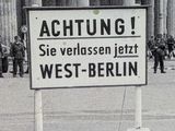 black and white photograph of a street sign in front of a building