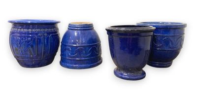 three blue vases are sitting next to each other on a white surface