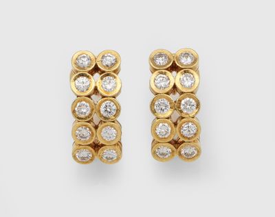 a pair of gold and diamond earrings