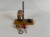 a small figurine of a man with a hat on a stand
