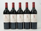 six bottles of red wine are lined up on a white surface